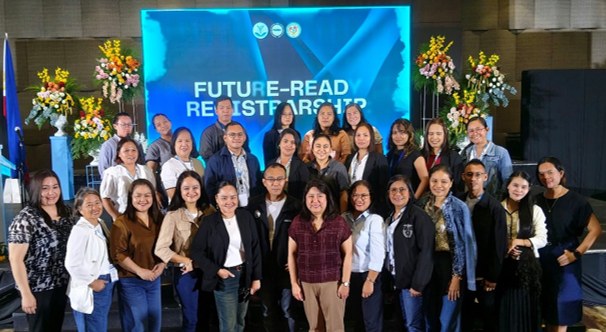 Participants of the FOSRA conference pose in front of the Future-Ready Registrarship stage at the Waterfront Hotel in Cebu City