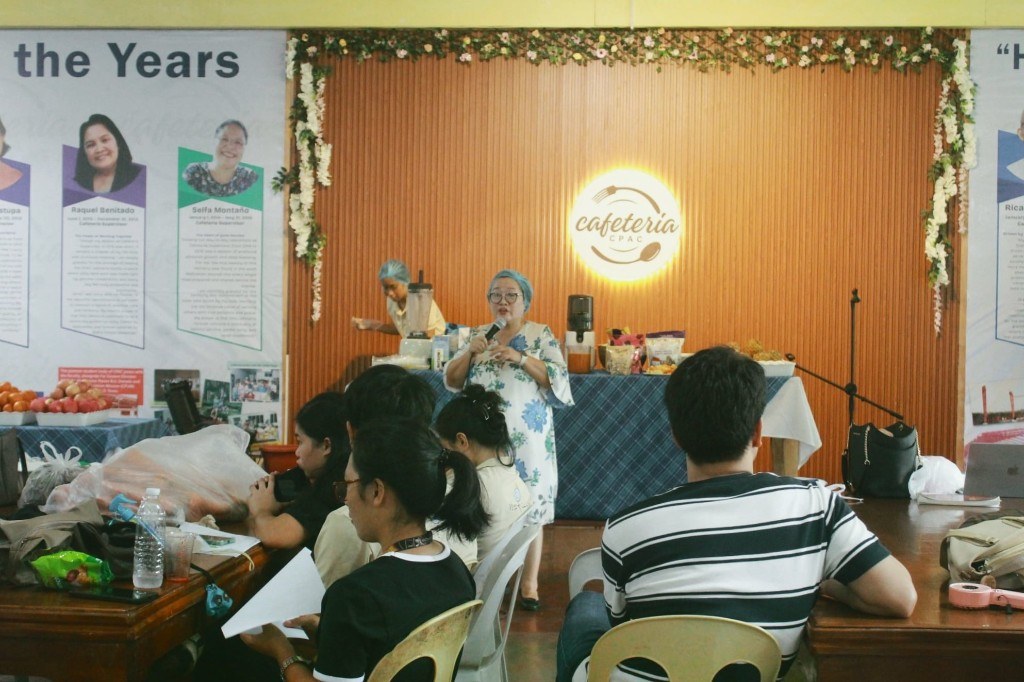 Dr. Neda June D. Salazar speaks to faculty and students during the healthy breakfast smoothie demonstration at the CPAC cafeteria
